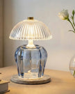 Blue glass vintage LED table lamp with ridged design, lighting up a small table, by Candlelight Products Ltd.