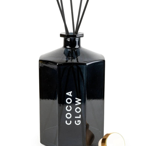Black octagonal reed diffuser from Candlelight Products Ltd, featuring a sleek design and reed sticks for fragrance diffusion.
