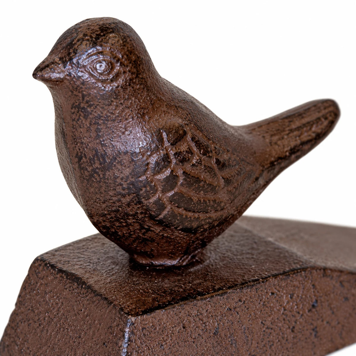 White studio close-up of the bird's feather detail and textured rust-brown cast iron finish.