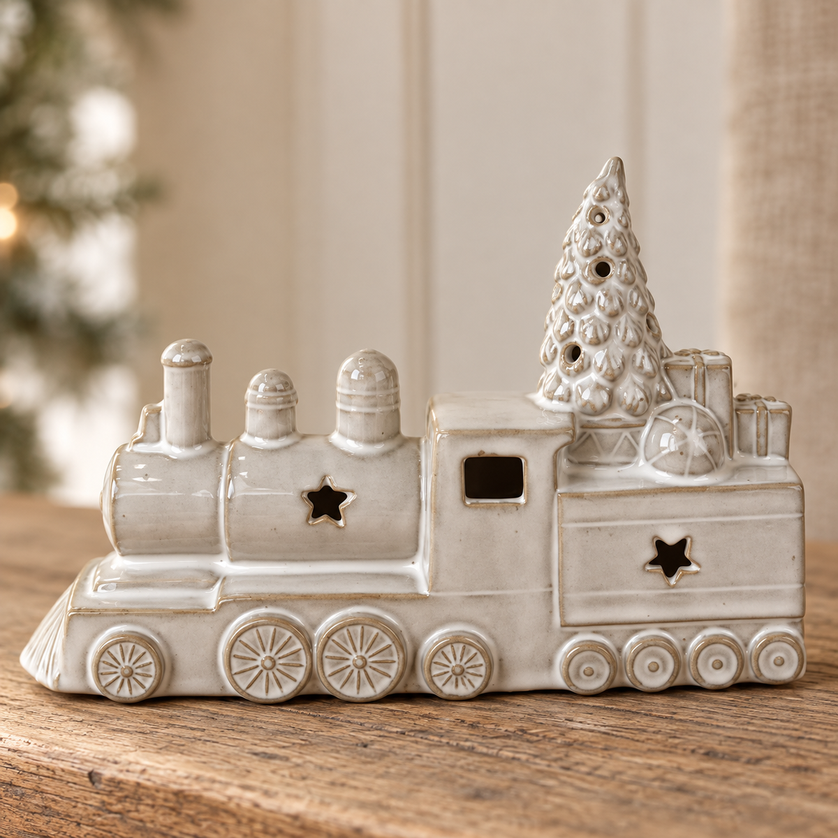 Close-up detail of the glazed ceramic Christmas train, wheels, stars and tree