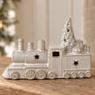 Close-up detail of the glazed ceramic Christmas train, wheels, stars and tree