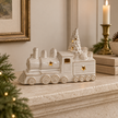 Glazed ceramic LED Christmas train styled on a warm stone mantel