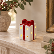 White and Red LED Ceramic Present styled in a warm neutral Christmas interior