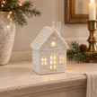 Large White LED Christmas Decorated House styled on a warm neutral mantel