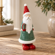 Close-up detail of Large Green Ceramic Santa Holding a Present