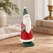 Close-up detail of Small Red Ceramic Santa Holding a Present