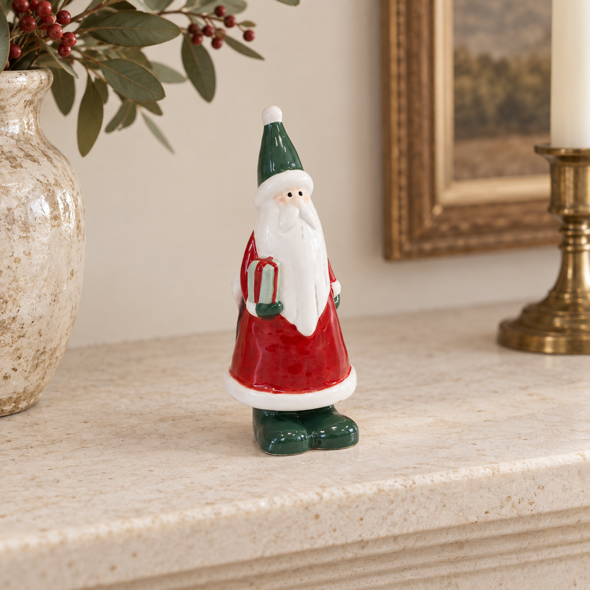 Small Red Ceramic Santa Holding a Present styled in a warm neutral Christmas interior