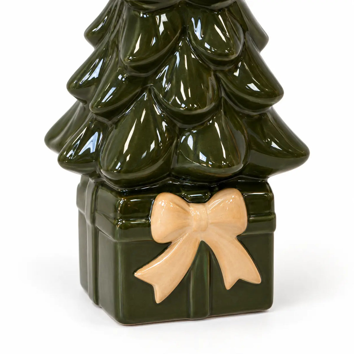 Close-up of the cream ceramic bow, green gift-shaped base and glazed tree branches.