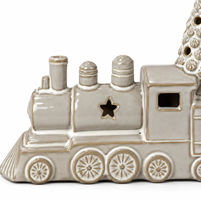 Close-up of the ceramic train's glaze, star cutout and raised wheel detailing