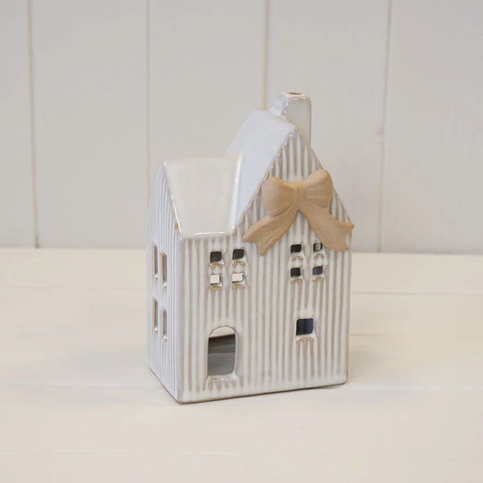 Large white ceramic tealight house with cream bow full product view on plain white background