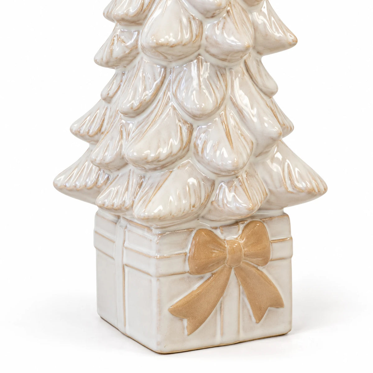 Close-up of the beige bow, gift-box base and ivory glazed branches of the ceramic Christmas tree.