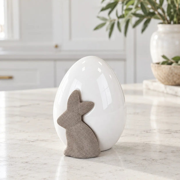 Satchville small white ceramic egg with rabbit decoration on a kitchen surface