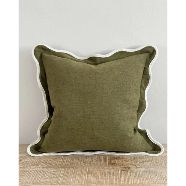 Olive green Chloe square cushion cover with scalloped edges, soft furnishings by Ellenvale Trade, displayed on a sofa.