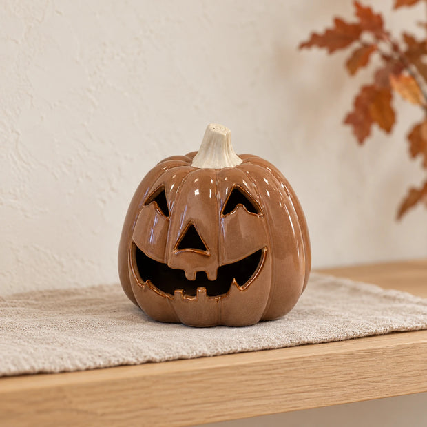 Chocolate brown pumpkin autumn decoration by Satchville on a shelf, perfect for fall seasonal decor.