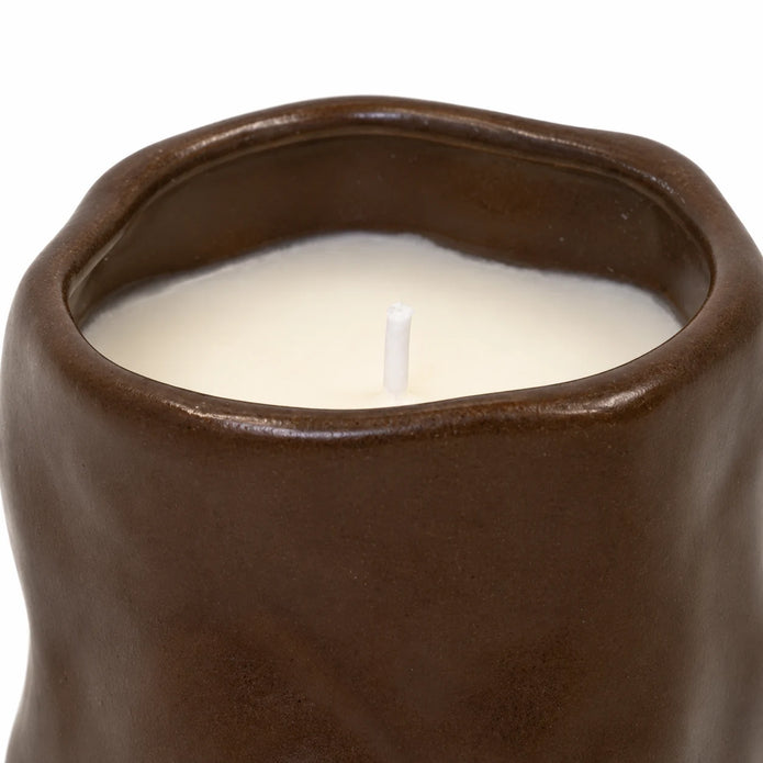 Close-up of the chocolate brown sculpted ceramic rim, cream wax and unlit wick