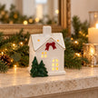 Satchville small Christmas home decoration with red bow displayed on a mantel