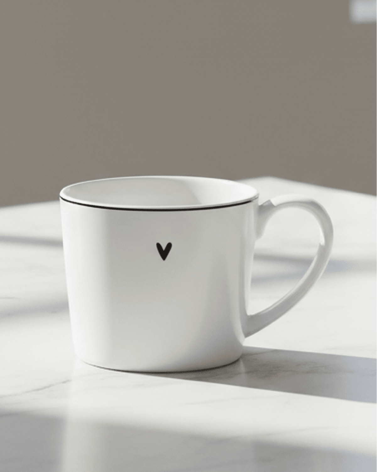 White ceramic mug featuring a black heart design from Clayre & Eef, perfect for kitchen and dining use.