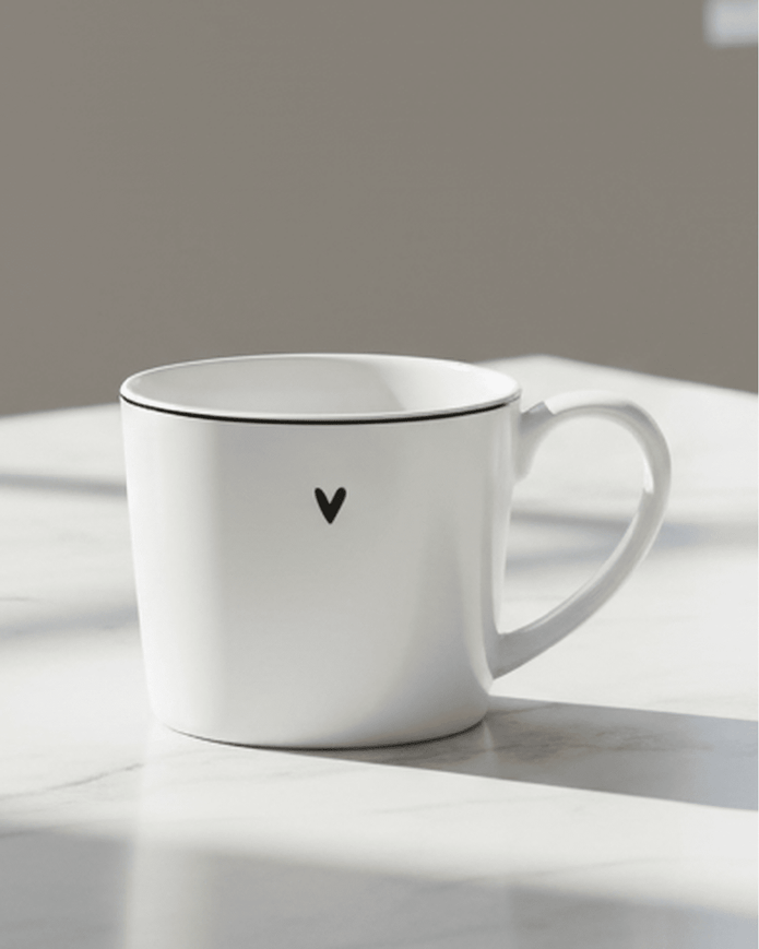White ceramic mug featuring a black heart design from Clayre & Eef, perfect for kitchen and dining use.