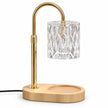 Candle warmer lamp with clear glass shade gold frame and wooden base on white