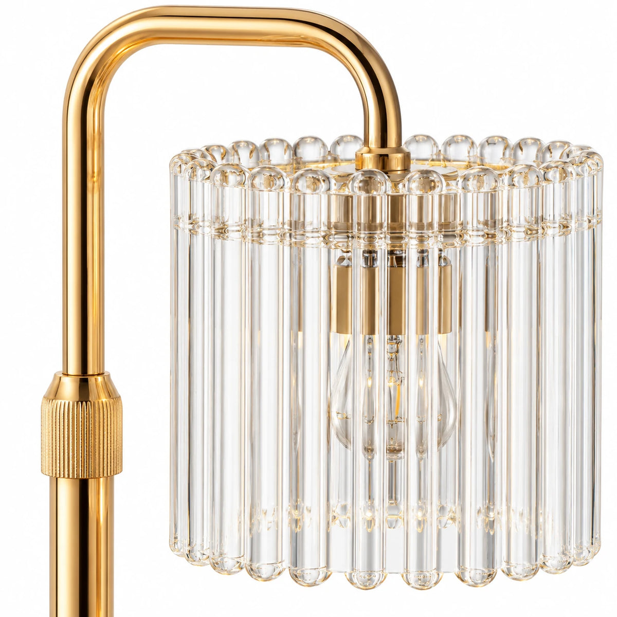 Close-up of the clear ribbed glass shade and gold-tone arm of the candle warmer lamp