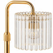Close-up of the clear ribbed glass shade and gold-tone arm of the candle warmer lamp