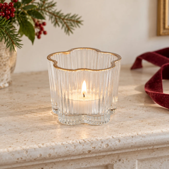 Clear ribbed glass tea light candle holder by Originals International Ltd on a mantelpiece