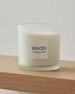 White Alang Alang large 3-wick candle by Coach House with tonka and clove scent, shown in a simple white candle holder.
