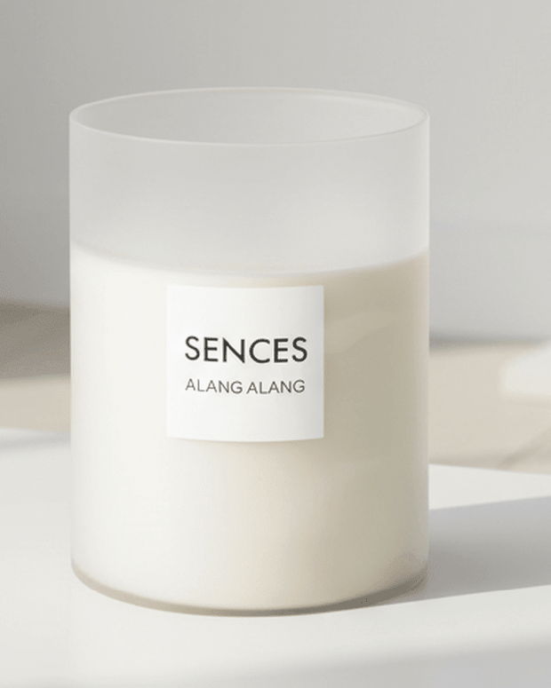 White Alang Alang XXL 7 Wick Candle by Coach House featuring a tall candle with white wax and multiple wicks, scented with tonka and clove.