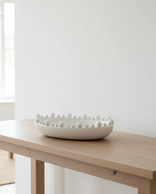 Large white oval bowl with bobble-edged design, ideal for home decor by Coach House, showcasing its decorative and functional style.