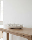 Large white oval bowl with bobble-edged design, ideal for home decor by Coach House, showcasing its decorative and functional style.