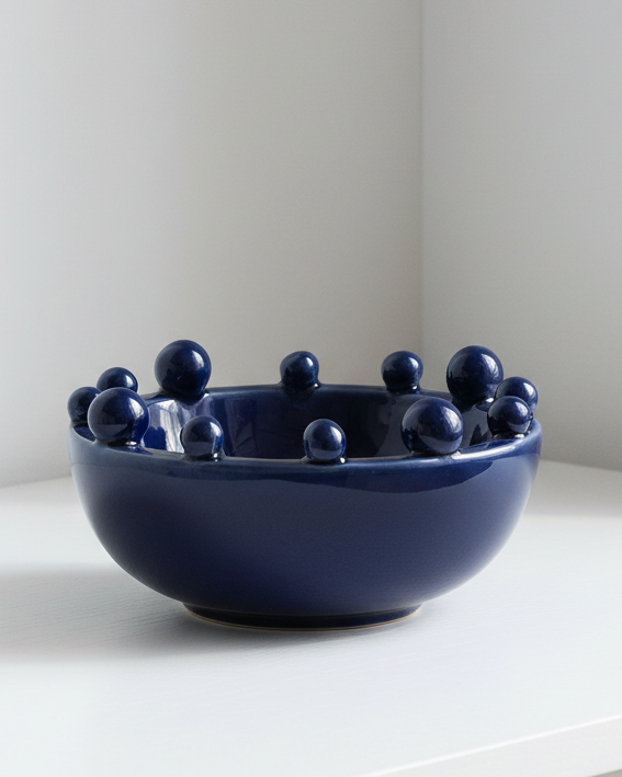 Small navy blue ceramic bowl with bobble-edged design, ideal for home decor by Coach House.