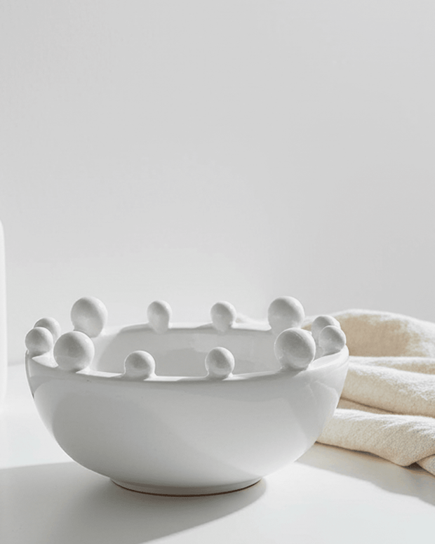 Small white bobble-edged bowl by Coach House, a stylish home decor piece with textured rim and smooth finish.
