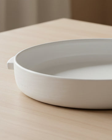 White ceramic stoneware Katja bowl by Coach House, elegant home decor piece with a smooth, glossy finish and modern design.