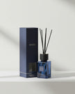 Navy blue Ocean small reed diffuser by Coach House, coastal home fragrance with reed sticks and decorative bottle.