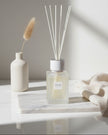 White Alang Alang large reed diffuser by Coach House, 500ml home fragrance with tonka and clove scent, displayed in a clear container.