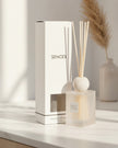 White Petra Reed Diffuser with travertine ball top and pink pepper scent, a stylish home fragrance by Coach House.