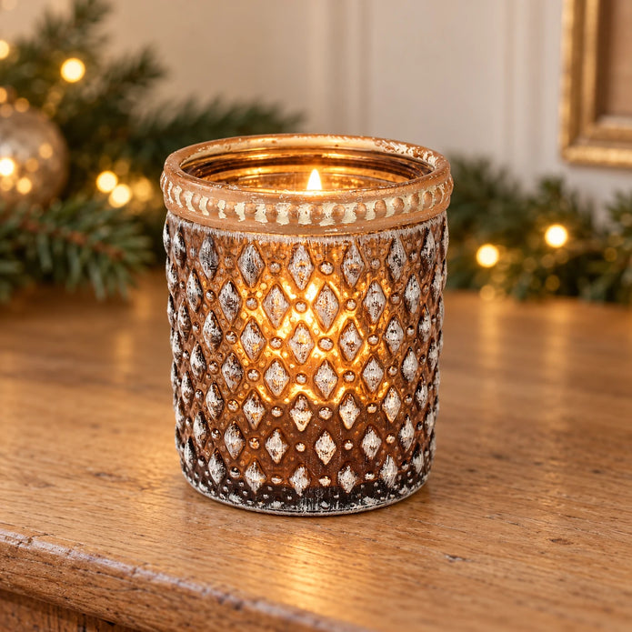 Cognac diamond glass tea light holder with distressed metal rim, styled with a lit tea light on an oak Christmas sideboard.