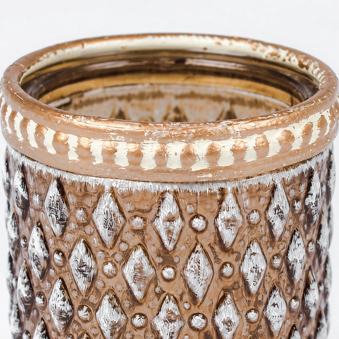 Close-up of the distressed metal rim and silver-white diamond texture on the cognac glass tea light holder.