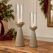 Small and Medium concrete hurricane candle holders styled on an oak Christmas console
