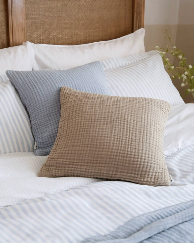 Ocean blue muslin cotton cushion cover by Riva Home, soft furnishings with a smooth, lightweight fabric and subtle texture.