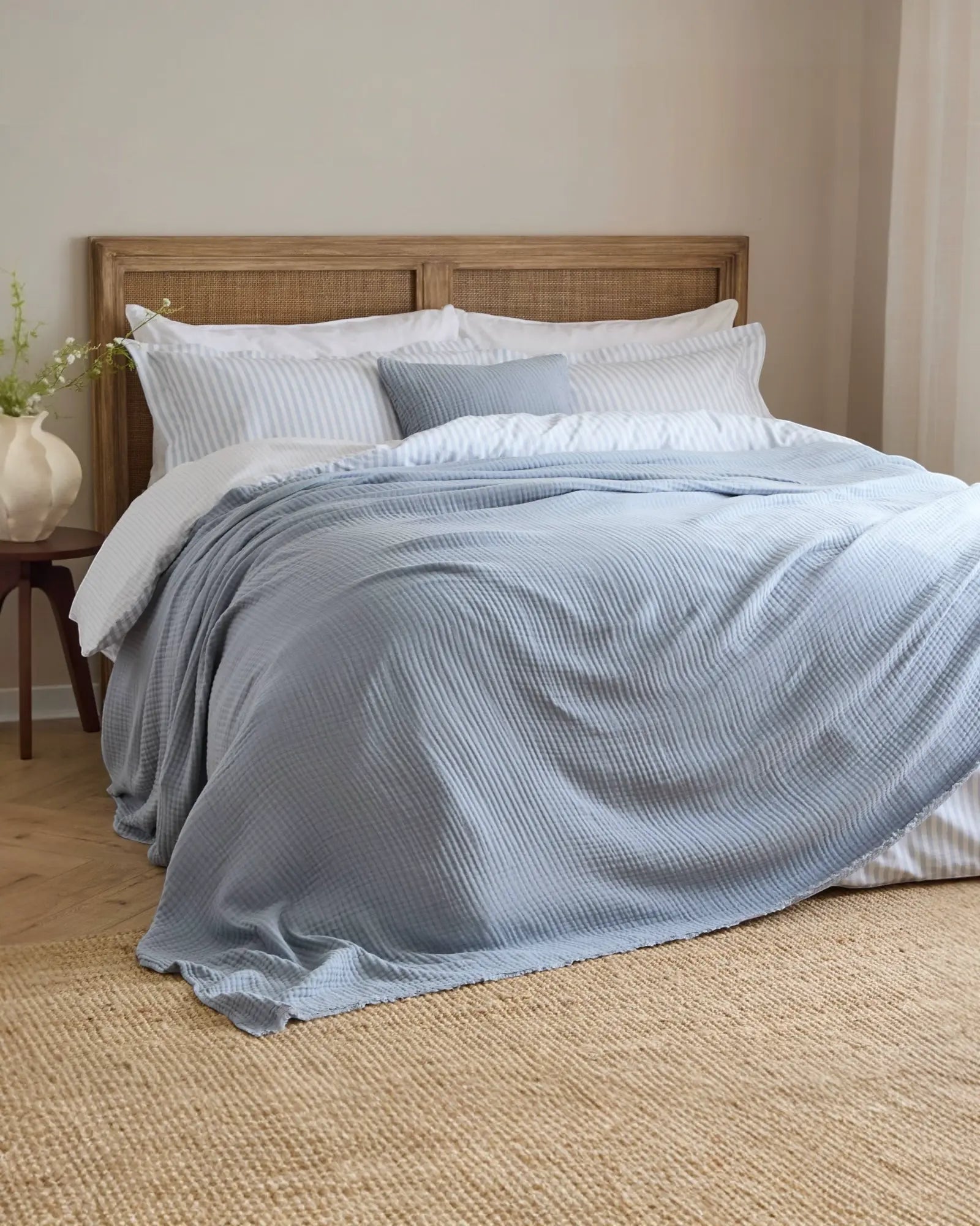 Riva Home Ocean Blue Muslin Cotton Throw Bed Cover, soft furnishings with a smooth, lightweight ocean blue fabric draped on a bed.