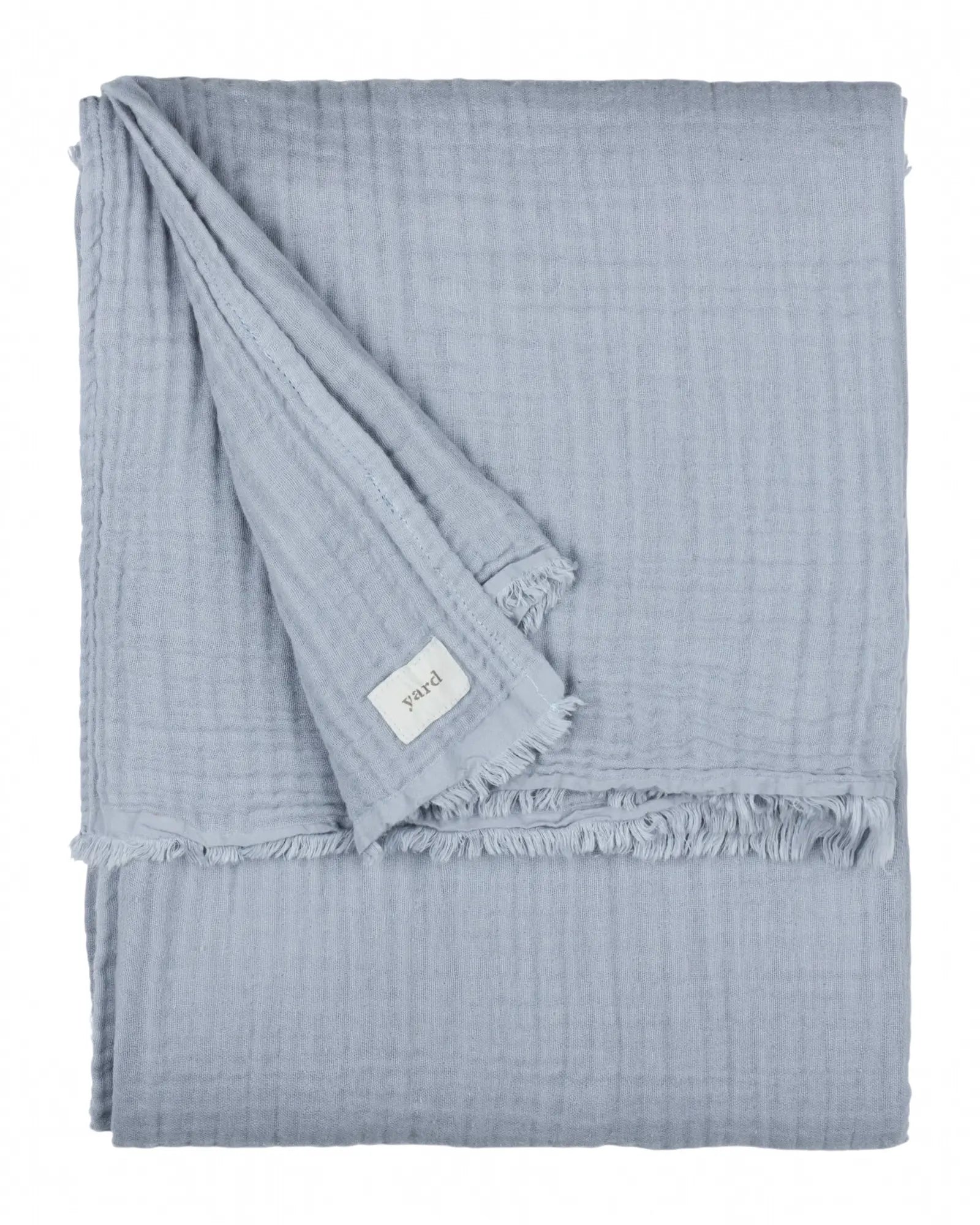 Riva Home ocean blue muslin cotton throw bed cover displayed on a bed, showcasing soft, lightweight furnishings for cozy bedroom decor.