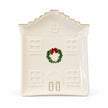 Full white studio view of the ivory house-shaped plate with green wreath and red bow.