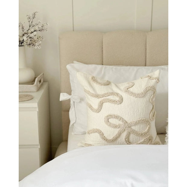 Cream and beige bow square boucle cushion cover by Starlight Express, soft furnishings with a textured boucle fabric and decorative bow detail.