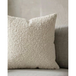 Cream boucle cushion cover from Starlight Express, soft furnishings with textured fabric and cozy appearance.
