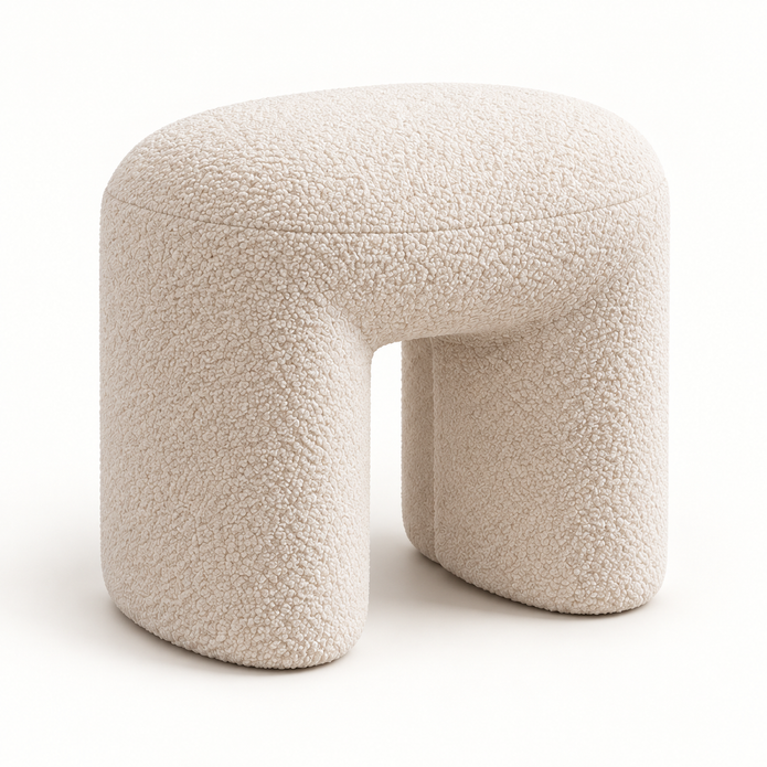 Side profile of cream boucle arched footstool