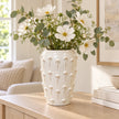 large ivory cream ceramic bobble vase with white flowers on a pale oak console