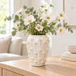 medium ivory cream ceramic bobble vase with white flowers on a pale oak console