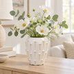 small ivory cream ceramic bobble vase with white flowers on a pale oak console