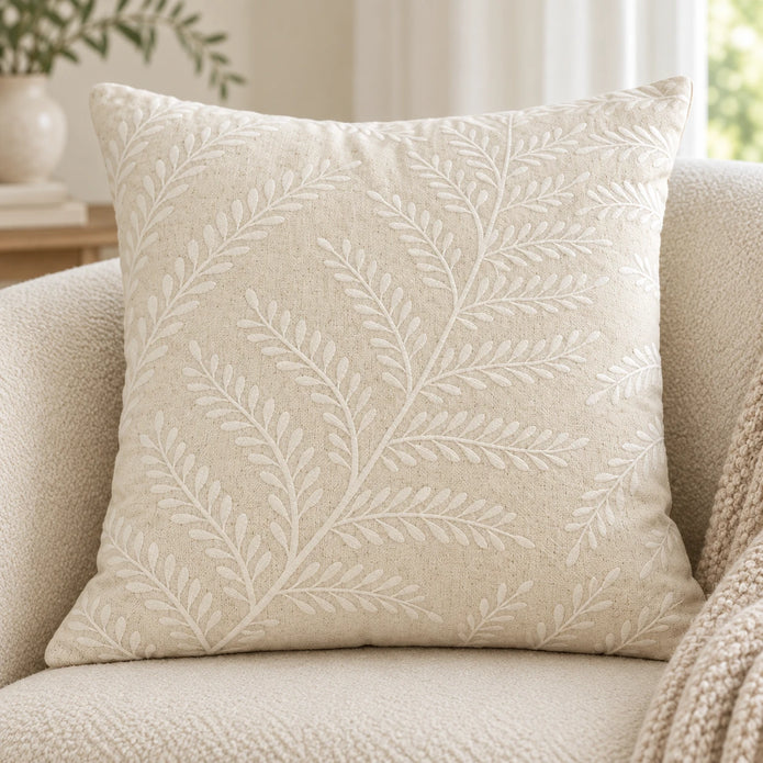 Cream Fern Embroidered Cushion Cover, closer view of the raised leaf pattern on a cream chair.